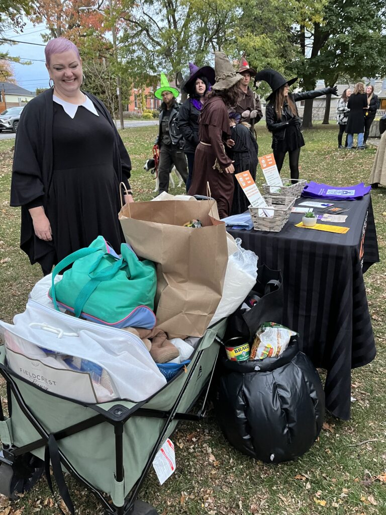 Brooke from Kingston Interval House with a mountain of donations at the 3rd annual Kingston Witches Walk